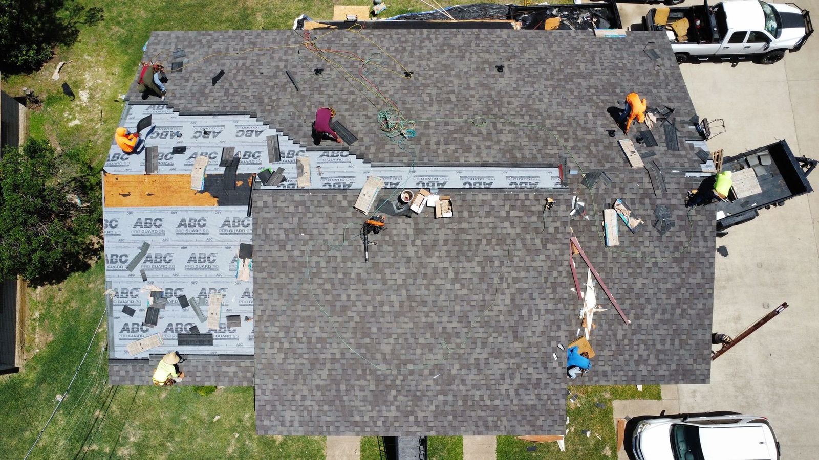 Crew installing asphalt shingles on a Cleburne-area home