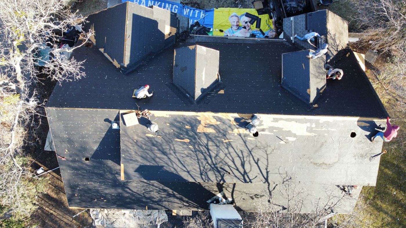 Roofing crew working on a residential roof