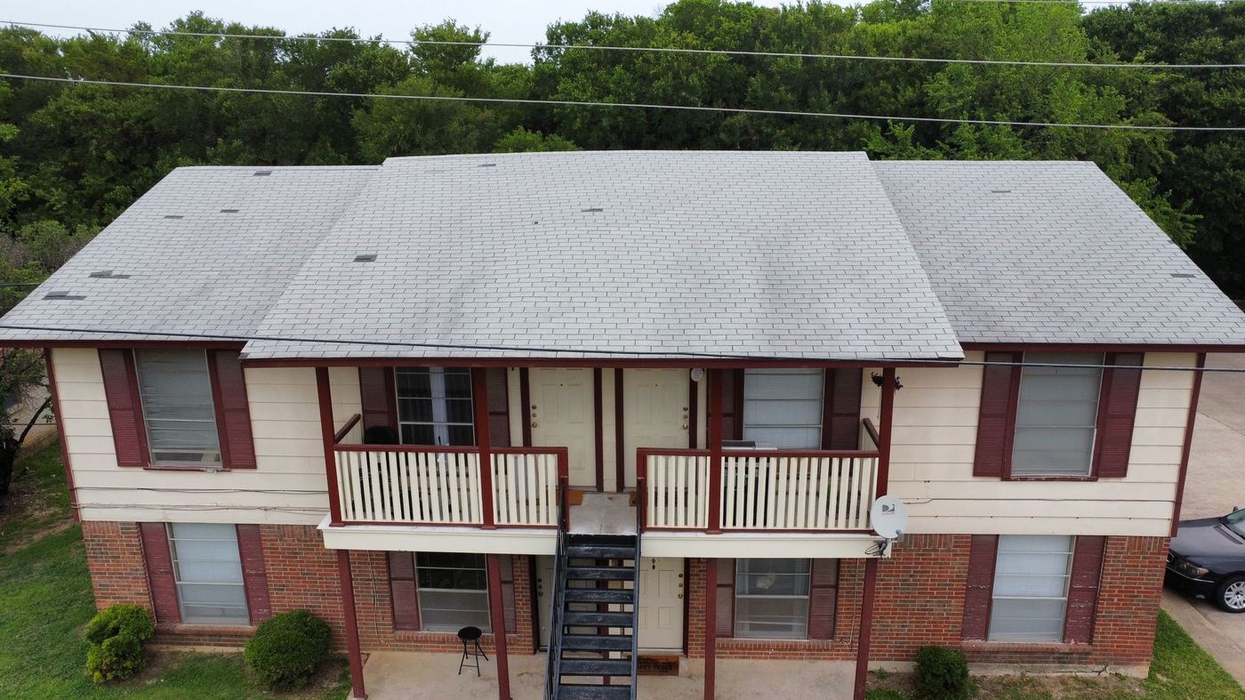 Roofing work on a multi-section home