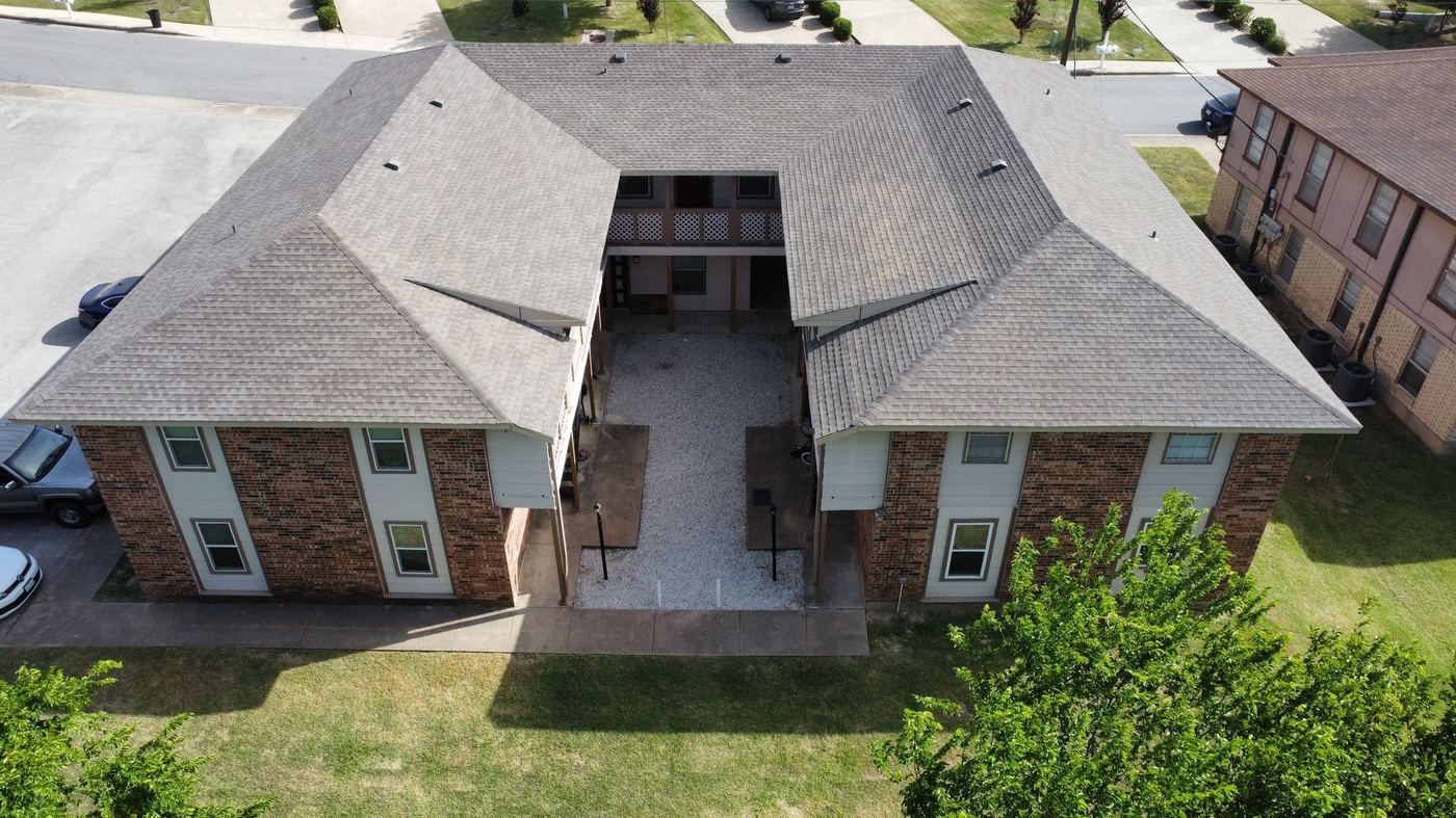 Crew installing underlayment and shingles